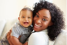 Black mother and child smiling at the camera